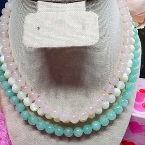 This 3-strand necklace features natural pink quartz, mother-of-pearl,  jadeite,